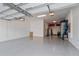 Spacious garage with epoxy flooring, ample storage cabinets, and overhead lighting at 15732 Shorebird Ln, Winter Garden, FL 34787
