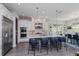 Open kitchen with white cabinets, a granite island with seating, stainless steel appliances, and modern finishes at 15732 Shorebird Ln, Winter Garden, FL 34787