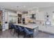 Spacious kitchen with white cabinetry, stainless steel appliances, a large island, and modern pendant lighting at 15732 Shorebird Ln, Winter Garden, FL 34787
