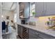 Featuring granite countertops, wine cooler, and stainless steel appliances, this kitchen is designed for the modern homeowner at 15732 Shorebird Ln, Winter Garden, FL 34787