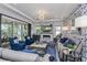 Bright living room with a cozy fireplace, sleek furniture, and sliding glass doors leading to the outdoors at 15732 Shorebird Ln, Winter Garden, FL 34787
