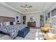 Bright and airy main bedroom with a large bed, seating area, and ensuite bathroom entrance at 15732 Shorebird Ln, Winter Garden, FL 34787
