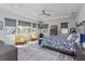 Large main bedroom with tray ceilings, ceiling fan, and multiple windows for ample natural light at 15732 Shorebird Ln, Winter Garden, FL 34787