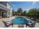 Relax and unwind by the pool with comfortable seating and a serene backyard view at 15732 Shorebird Ln, Winter Garden, FL 34787