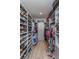 Walk-in closet with custom shelving and storage for shoes, clothes, and luggage at 15732 Shorebird Ln, Winter Garden, FL 34787