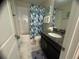 Well-lit bathroom featuring a shower-tub combo and a granite vanity with under-mount sink at 1580 Tempo Ln, Davenport, FL 33896