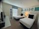 Comfortable bedroom with twin beds, complemented by a window and tasteful decorations at 1580 Tempo Ln, Davenport, FL 33896