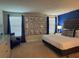 Stylish primary bedroom with a tufted headboard, gallery wall, and a calming blue color palette at 1580 Tempo Ln, Davenport, FL 33896