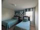 Inviting bedroom with twin beds, playful decor, and a coordinating color scheme at 1580 Tempo Ln, Davenport, FL 33896