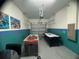 Finished garage converted into a game room featuring air hockey and foosball tables at 1580 Tempo Ln, Davenport, FL 33896