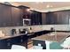 Well-equipped kitchen with dark cabinetry and stainless steel appliances at 1580 Tempo Ln, Davenport, FL 33896