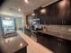 Modern kitchen features granite countertops, stainless steel appliances, and sleek dark wood cabinetry at 1580 Tempo Ln, Davenport, FL 33896