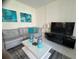 Comfortable living room featuring a stylish gray sofa and modern décor at 1580 Tempo Ln, Davenport, FL 33896