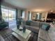 Cozy living room with a large sectional sofa and view of the pool area at 1580 Tempo Ln, Davenport, FL 33896