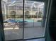 View of the enclosed pool and patio area from the interior at 1580 Tempo Ln, Davenport, FL 33896