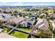 Aerial view of the house in a residential neighborhood, complete with green lawn, and a white picket fence at 15863 Citrus Grove Loop, Winter Garden, FL 34787