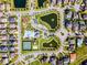 Overhead aerial view of the community showing tennis courts, pool, clubhouse, ponds, and playground at 15863 Citrus Grove Loop, Winter Garden, FL 34787
