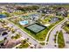 Aerial view showing community amenities including tennis courts, pool, clubhouse, playground, and ponds at 15863 Citrus Grove Loop, Winter Garden, FL 34787
