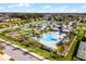 Aerial view of the community pool and clubhouse, a park, and a pond with a fountain at 15863 Citrus Grove Loop, Winter Garden, FL 34787