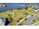 Stunning aerial view of a community park, lake, and surrounding neighborhood with manicured lawns and walking trails at 15863 Citrus Grove Loop, Winter Garden, FL 34787