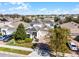 Aerial view of a two-story home featuring blue shutters, a well-manicured lawn, and a brick driveway in a residential area at 15863 Citrus Grove Loop, Winter Garden, FL 34787