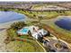 Aerial view of the community pool, clubhouse, tennis court, and lakefront recreation area at 15863 Citrus Grove Loop, Winter Garden, FL 34787