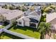 Aerial view of the home's backyard, showing the brick patio, lush lawn, and white fenced perimeter at 15863 Citrus Grove Loop, Winter Garden, FL 34787