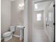 Clean half bathroom with pedestal sink is conveniently located near an extra room at 15863 Citrus Grove Loop, Winter Garden, FL 34787
