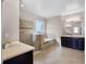 Elegant bathroom featuring a soaking tub, walk-in shower, and dual vanities at 15863 Citrus Grove Loop, Winter Garden, FL 34787