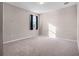 Neutral bedroom with carpet and natural light features a single window with blue curtains at 15863 Citrus Grove Loop, Winter Garden, FL 34787