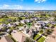 Aerial shot of a community pool, a tennis court, and a playground with a lake in the distance at 15863 Citrus Grove Loop, Winter Garden, FL 34787