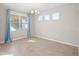Elegant dining room featuring tile flooring, a chandelier, and a window with light-blue curtains at 15863 Citrus Grove Loop, Winter Garden, FL 34787