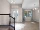 Welcoming foyer featuring tile flooring, staircase and lots of natural light at 15863 Citrus Grove Loop, Winter Garden, FL 34787
