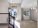 Bright foyer with a staircase, tile flooring, and natural light streaming through the front door at 15863 Citrus Grove Loop, Winter Garden, FL 34787