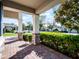 Inviting front porch area featuring brick pavers, stone pillars, and manicured hedges at 15863 Citrus Grove Loop, Winter Garden, FL 34787