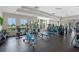 Well-lit community gym with plenty of exercise equipment and floor to ceiling windows at 15863 Citrus Grove Loop, Winter Garden, FL 34787