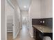 Bright hallway with tile floors features granite counters and provides access to multiple rooms at 15863 Citrus Grove Loop, Winter Garden, FL 34787