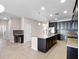 Open kitchen with dark cabinets, stainless steel appliances, granite countertops, and a large island, ideal for entertaining at 15863 Citrus Grove Loop, Winter Garden, FL 34787