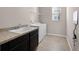 Bright laundry room features modern washer and dryer, countertop, and natural light at 15863 Citrus Grove Loop, Winter Garden, FL 34787
