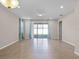Bright living room showcasing tile flooring, recessed lighting, large windows with curtains, and a seamless flow to the outdoors at 15863 Citrus Grove Loop, Winter Garden, FL 34787