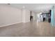 Open living room with tile floors, recessed lighting, flowing into an adjacent kitchen, and a light-colored walls at 15863 Citrus Grove Loop, Winter Garden, FL 34787