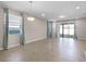 Bright living room features large windows with curtains, recessed lighting, and tile flooring, creating an airy and inviting space at 15863 Citrus Grove Loop, Winter Garden, FL 34787