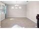 Bright living room with tile flooring, a chandelier, and a window with light-blue curtains at 15863 Citrus Grove Loop, Winter Garden, FL 34787