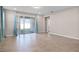 Large living room with tile floors, recessed lighting, and sliding glass doors leading to the backyard, perfect for gatherings at 15863 Citrus Grove Loop, Winter Garden, FL 34787
