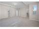 Large main bedroom featuring a tray ceiling, carpeted floors, and ample closet space at 15863 Citrus Grove Loop, Winter Garden, FL 34787