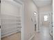 Spacious pantry with wire shelving is conveniently located near the bathroom and laundry room at 15863 Citrus Grove Loop, Winter Garden, FL 34787