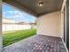Outdoor patio area with brick pavers and a view of the well-maintained, grassy backyard and white vinyl fence at 15863 Citrus Grove Loop, Winter Garden, FL 34787