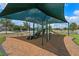 Outdoor playground with slides and climbing structure covered by a sunshade at 15863 Citrus Grove Loop, Winter Garden, FL 34787