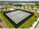 Aerial view of the community tennis courts surrounded by green grass and manicured landscaping at 15863 Citrus Grove Loop, Winter Garden, FL 34787