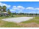 Outdoor sand volleyball court with a community building and lush green grass at 15863 Citrus Grove Loop, Winter Garden, FL 34787